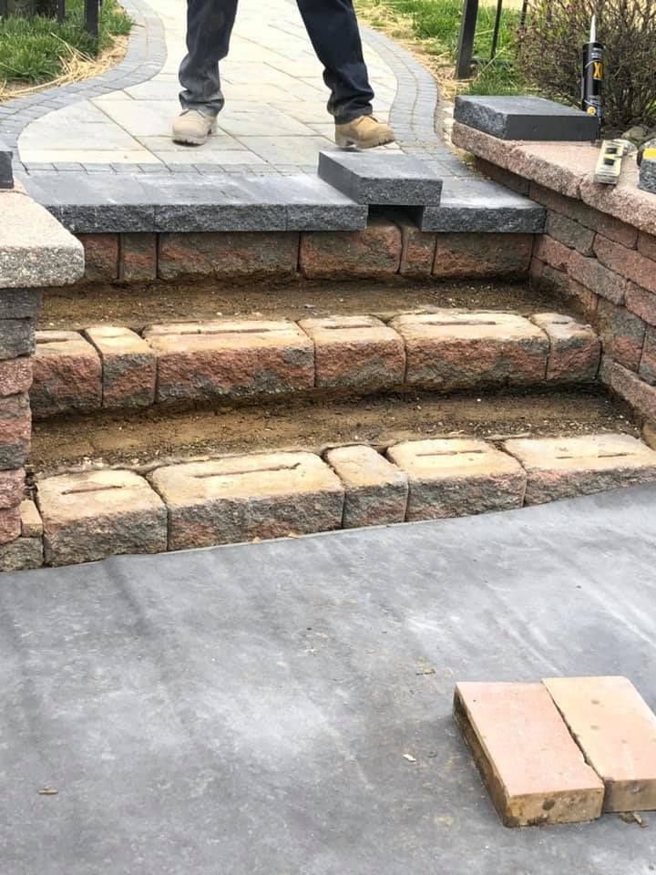 A man is standing on a set of brick steps