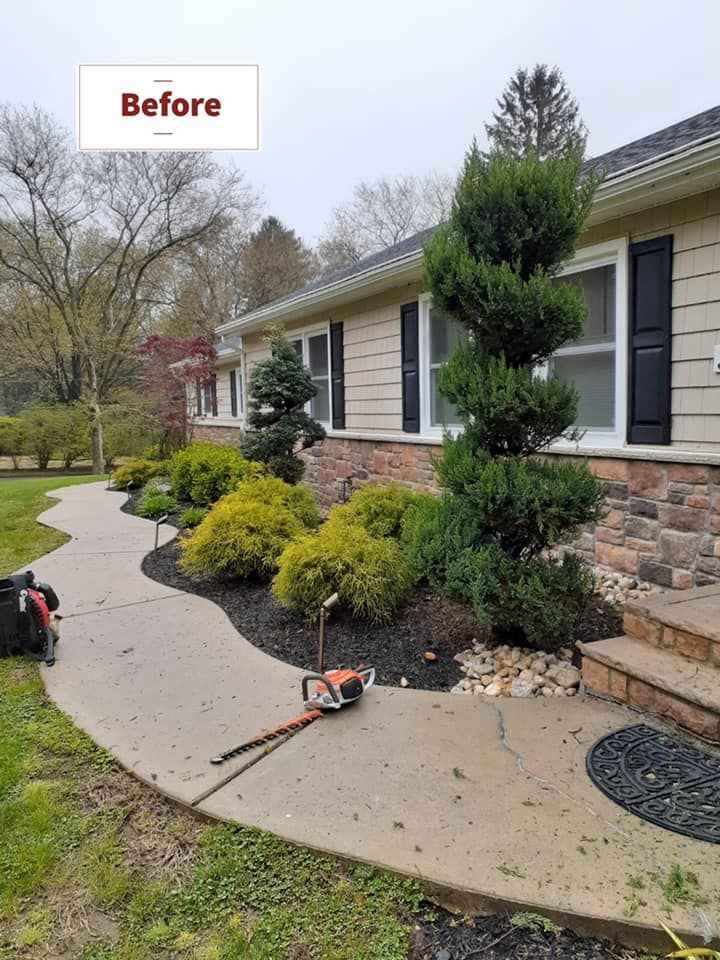A before picture of a house with a lawn mower on the sidewalk.