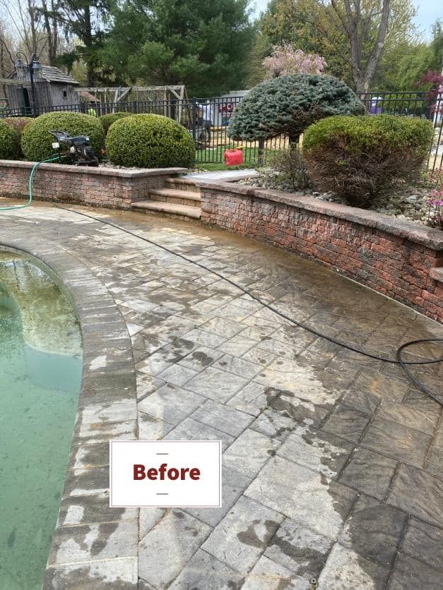 A before picture of a patio next to a pool.