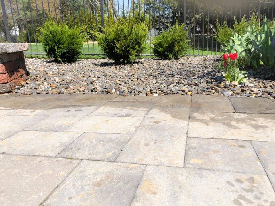 A patio with a bench and a fence