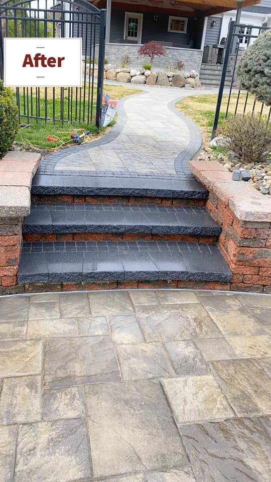 A brick walkway with steps leading up to a house