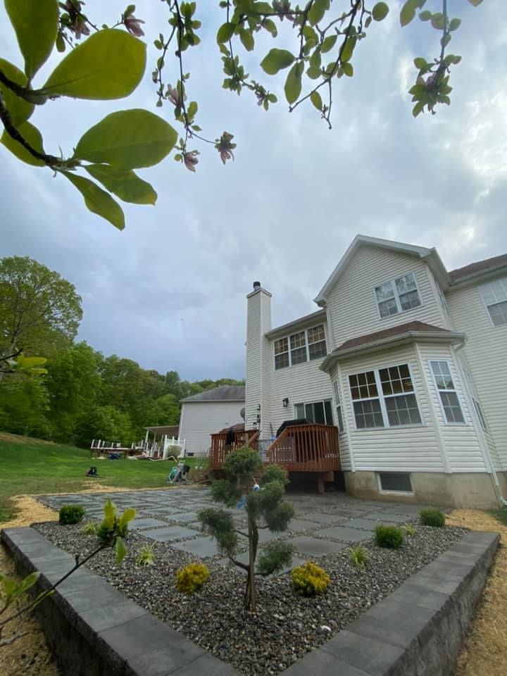 A house with a patio and a tree in front of it