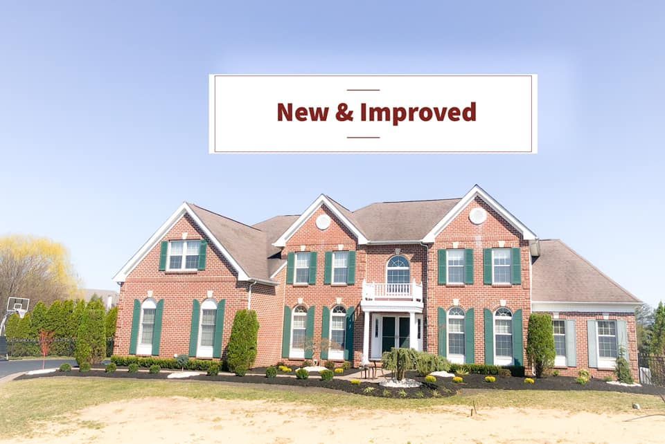 A large brick house with green shutters