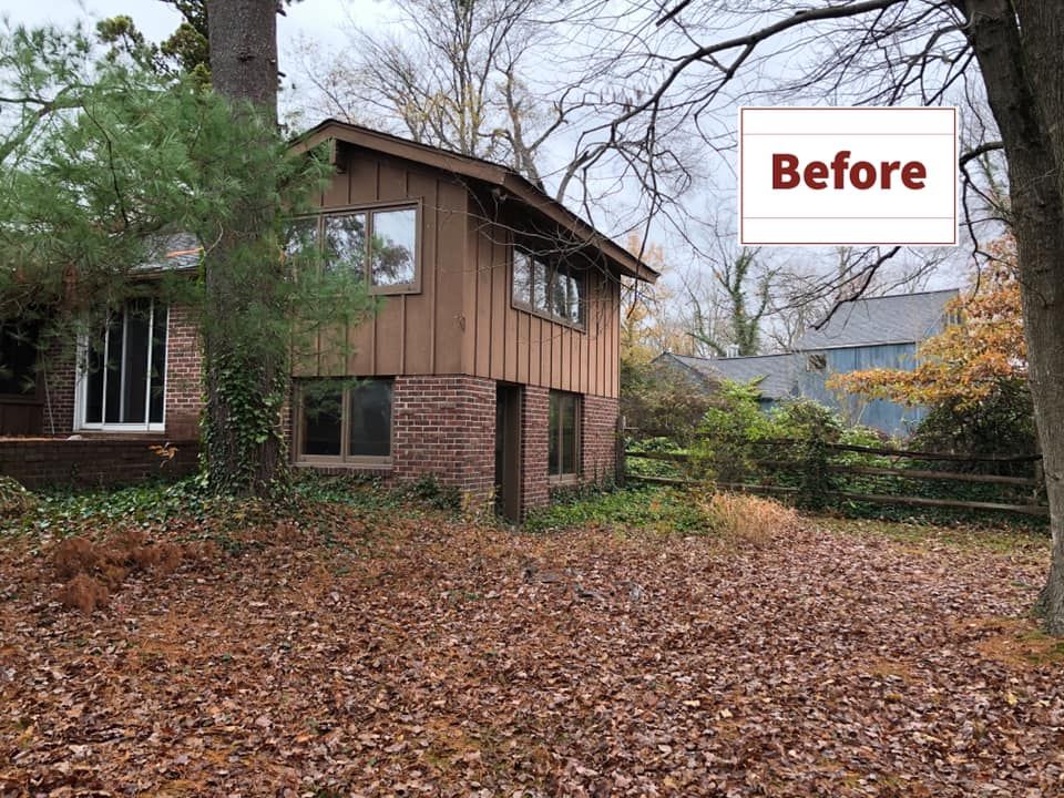 A before picture of a house with a lot of leaves on the ground.