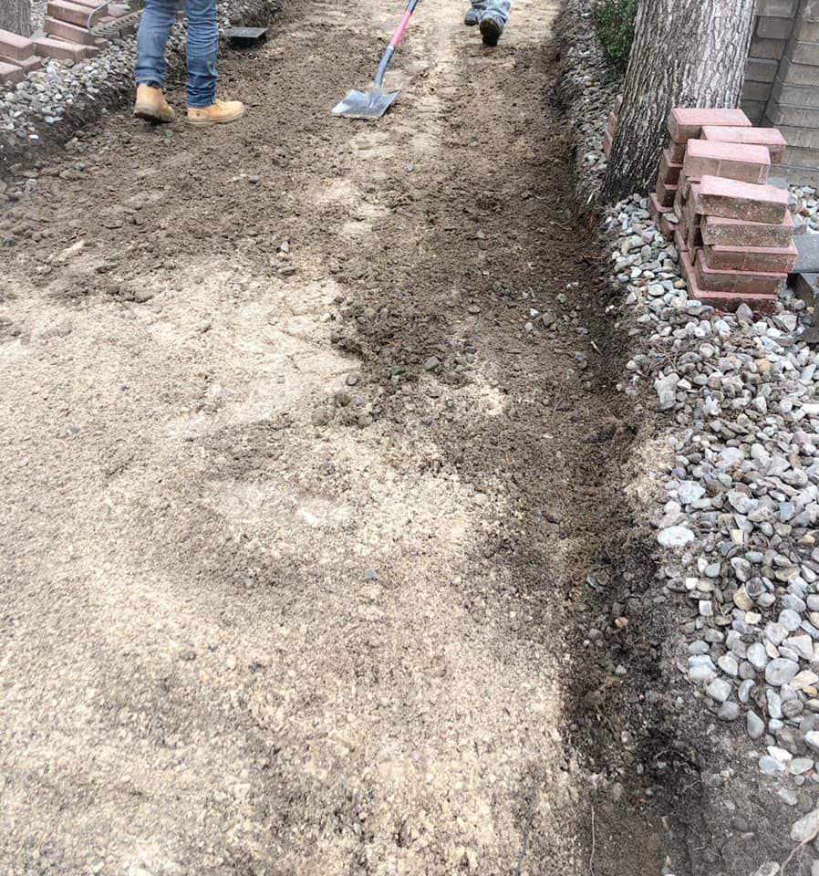 A person is digging a hole in the ground with a shovel