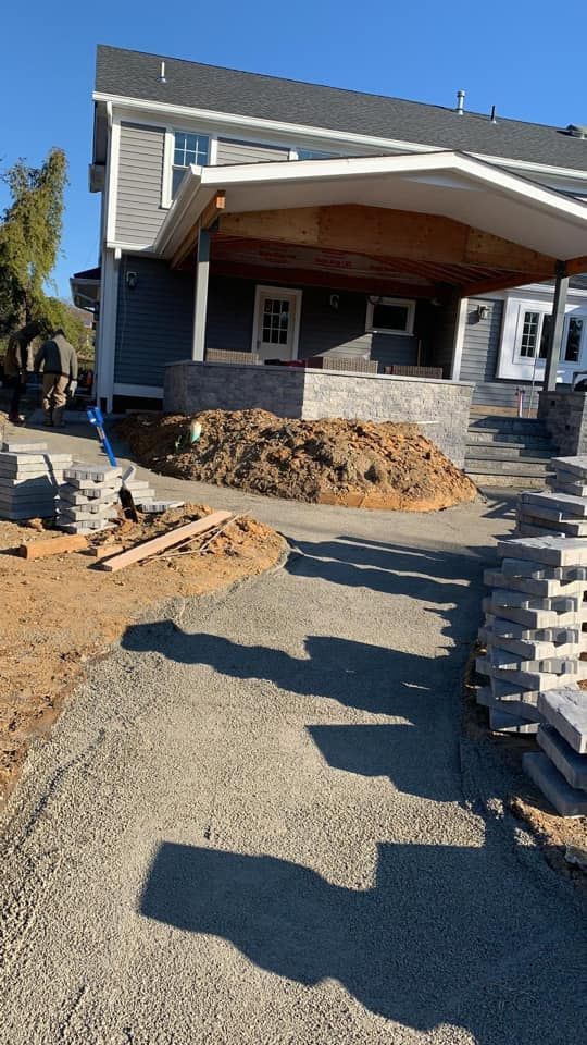 A house under construction with a lot of dirt in front of it