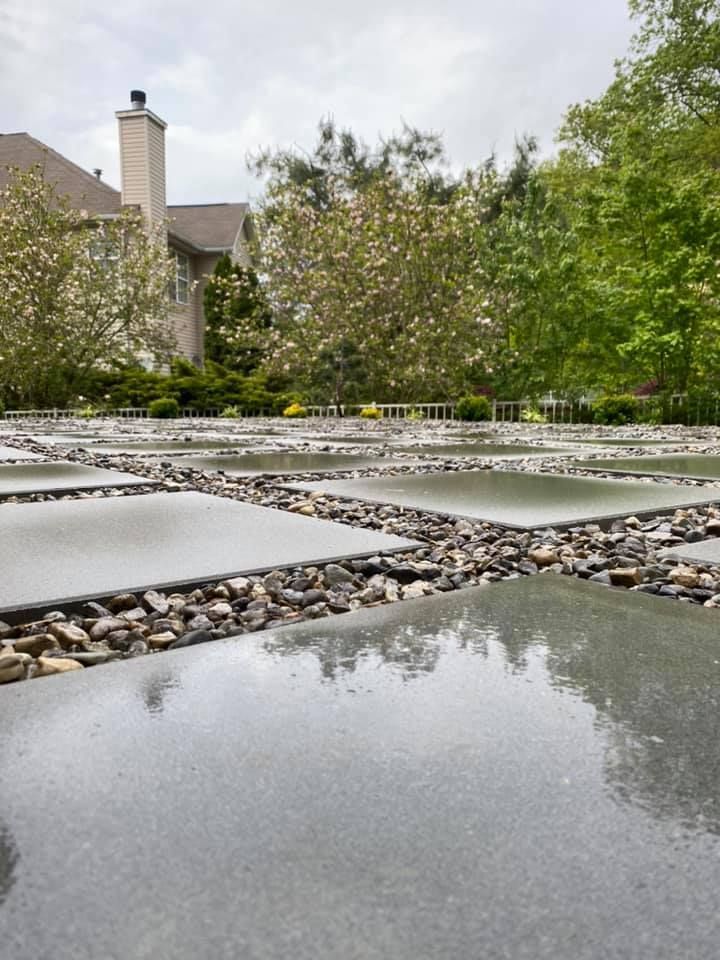 There is a large house in the background and a large body of water in the foreground