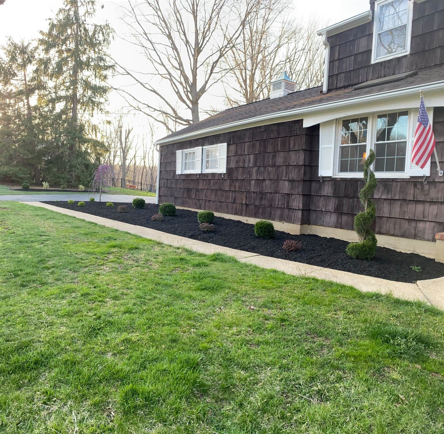A house with a large lawn in front of it.