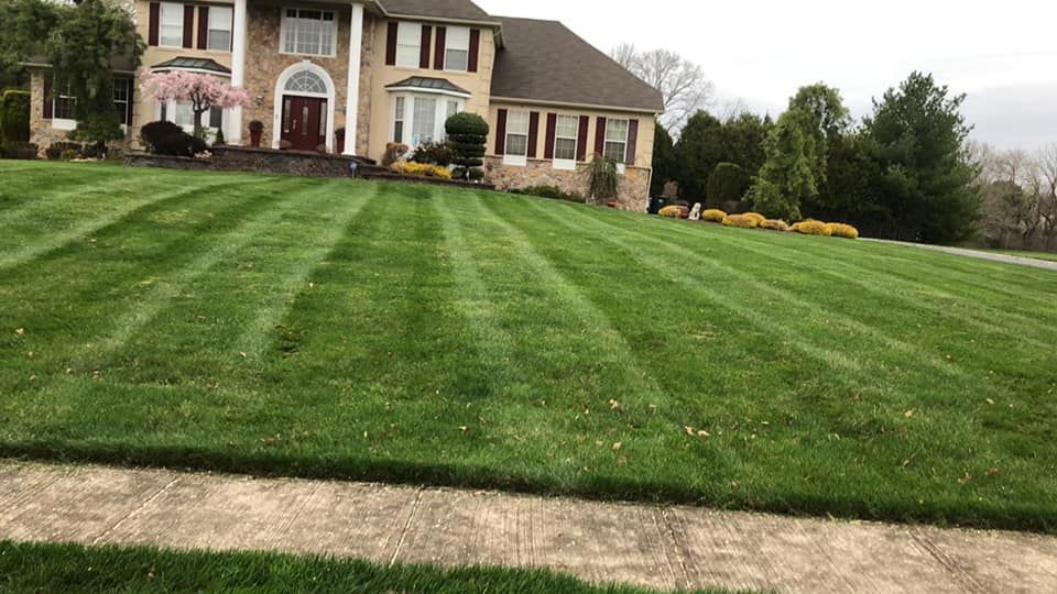 A large house with a lush green lawn in front of it.
