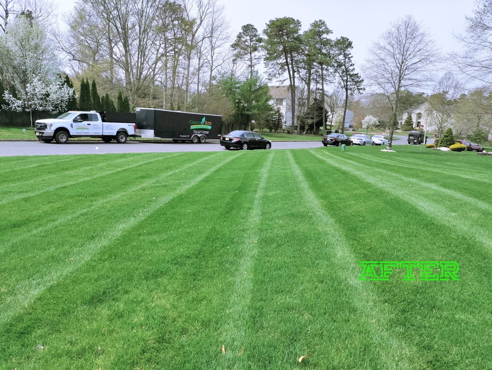 A lawn mower is cutting a lush green lawn.