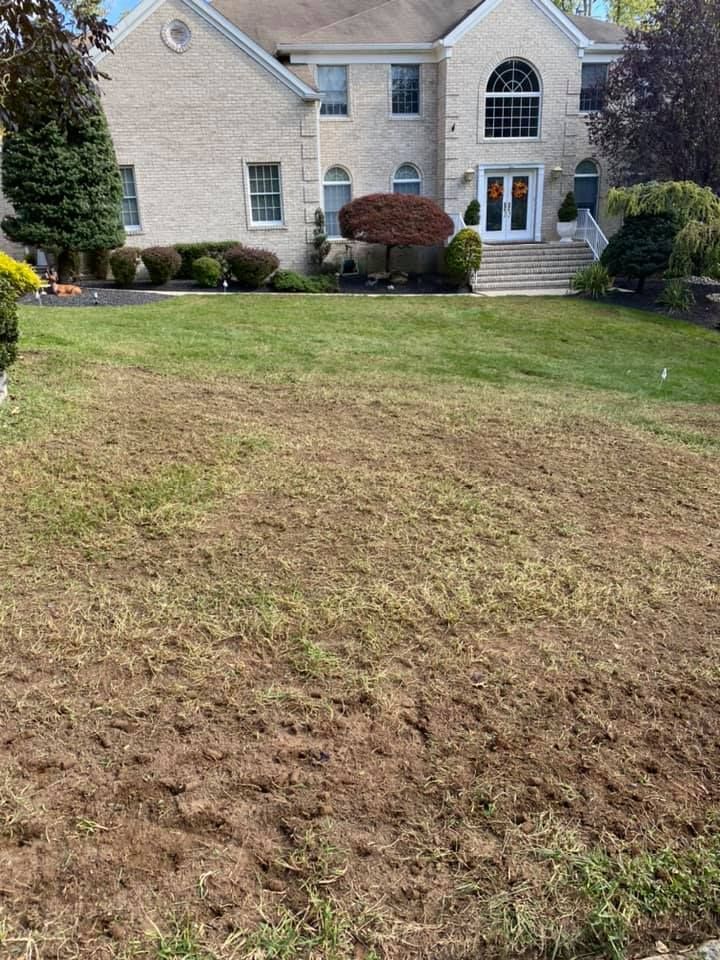 A large brick house with a large lawn in front of it