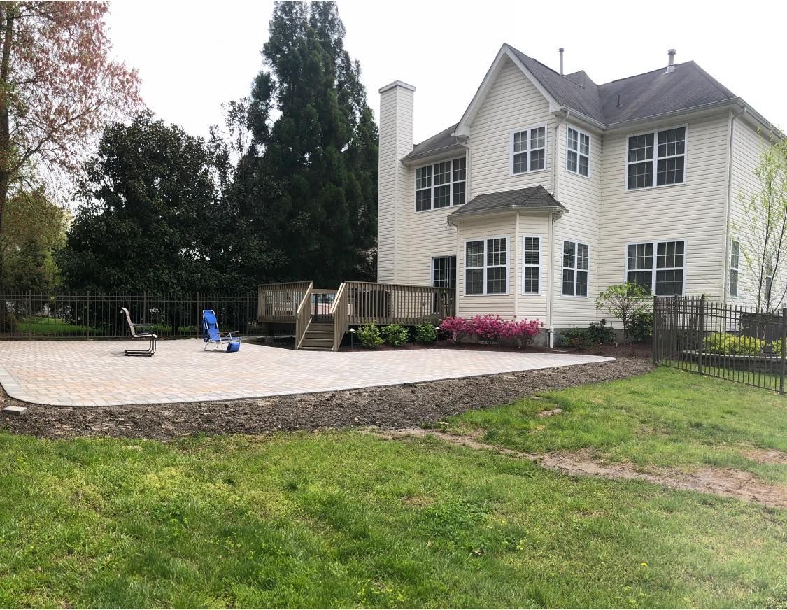 A large white house with a large patio in front of it.