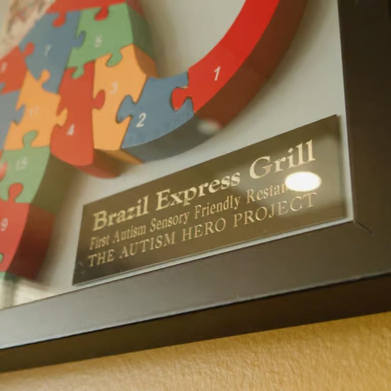 Sign for Brazil Express Grill, an Autism Hero Project sensory-friendly restaurant, with colorful puzzle rings nearby
