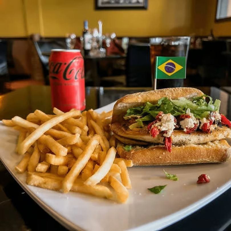 Burger and fries with a Coca-Cola can and Brazil flag on a restaurant table