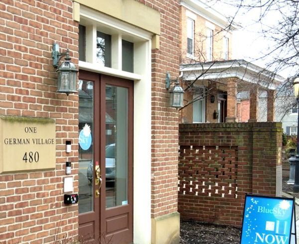 A brick building with a sign that says one german village 480