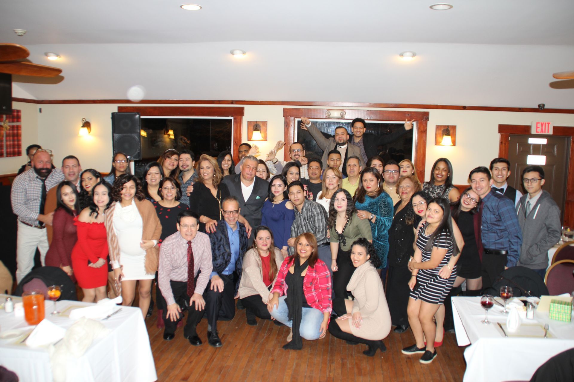 A large group of people are posing for a picture in a room.