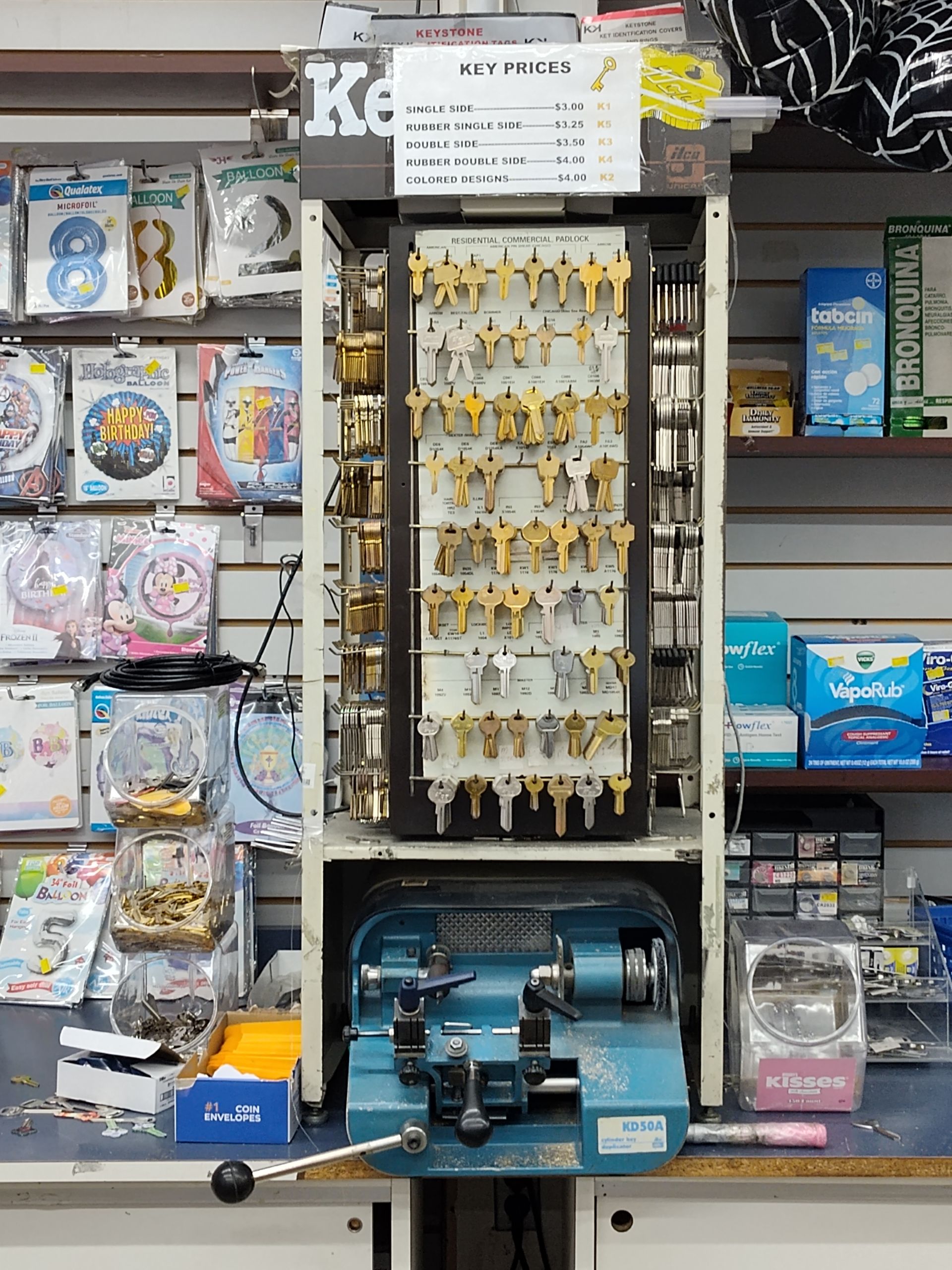 A key machine is sitting on a counter in a store.