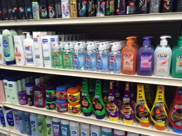 A store shelf filled with lots of hair products including silk