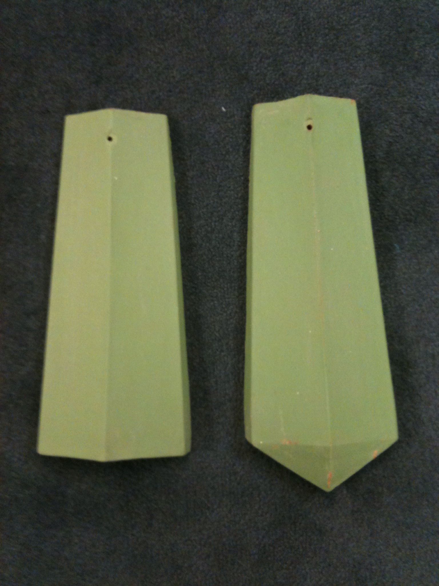 Two pieces of custom roof tile are sitting next to each other