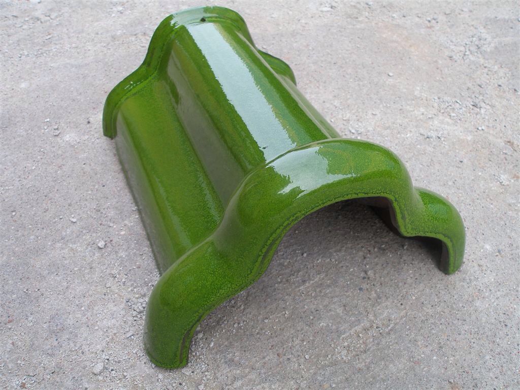 A green roof tile is sitting on the ground