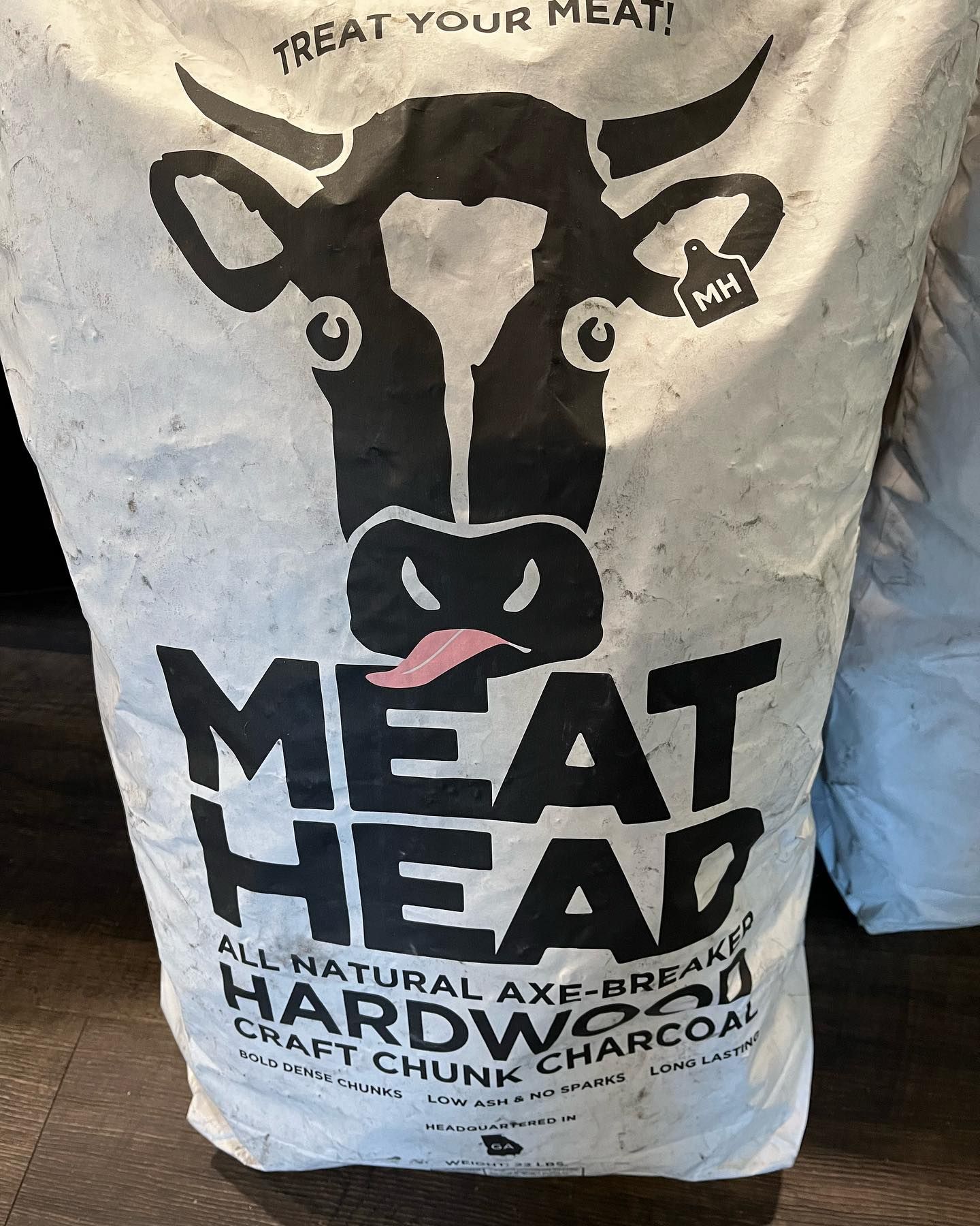 Bag of Meathead Hardwood Charcoal with a cow graphic.