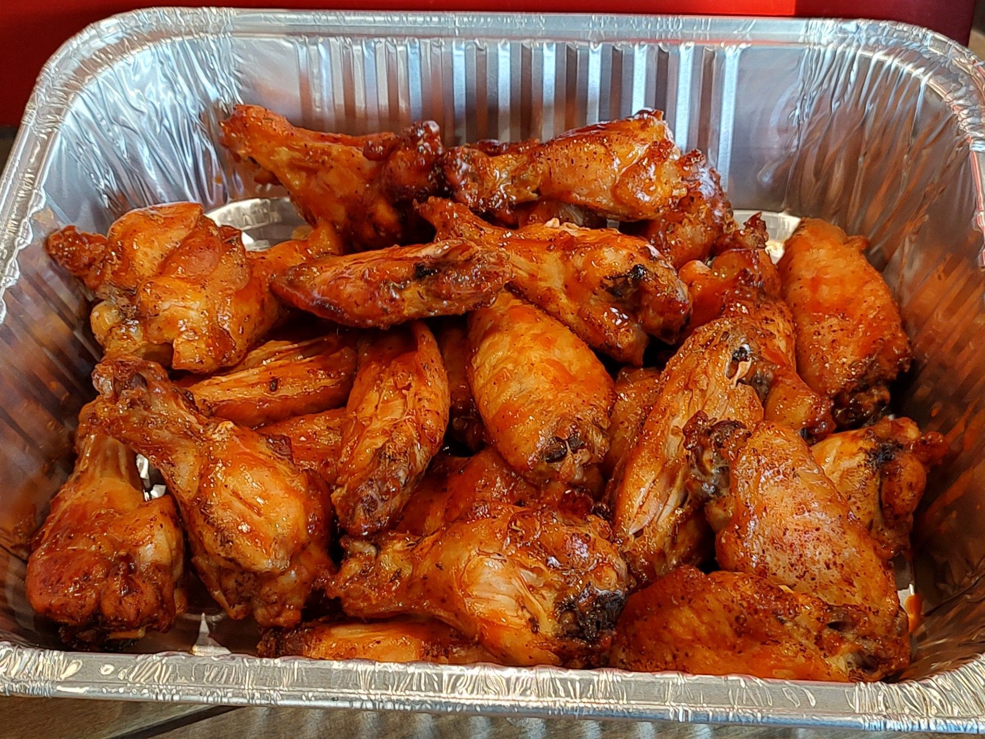 A tray of golden, seasoned chicken wings.