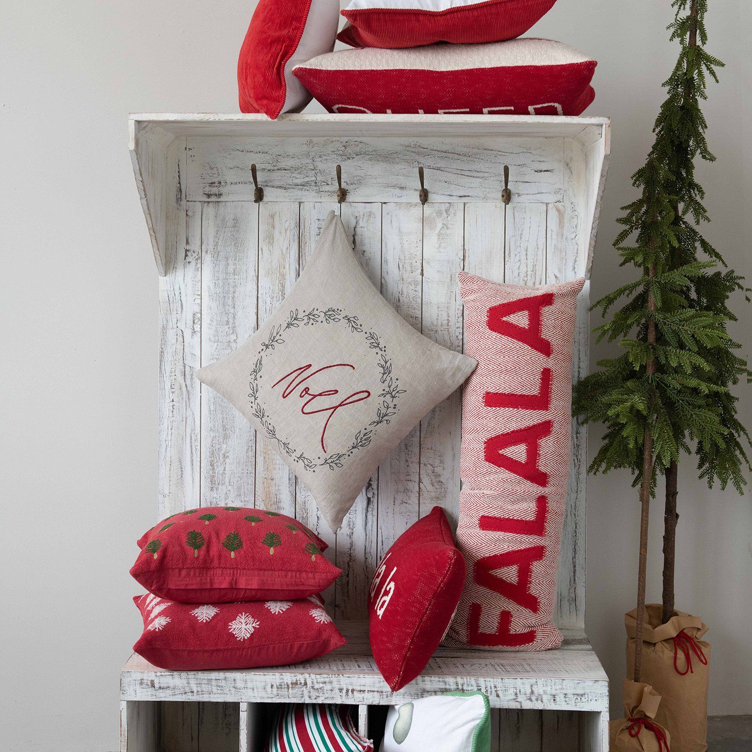 A shelf with red pillows and a sign that says kaala