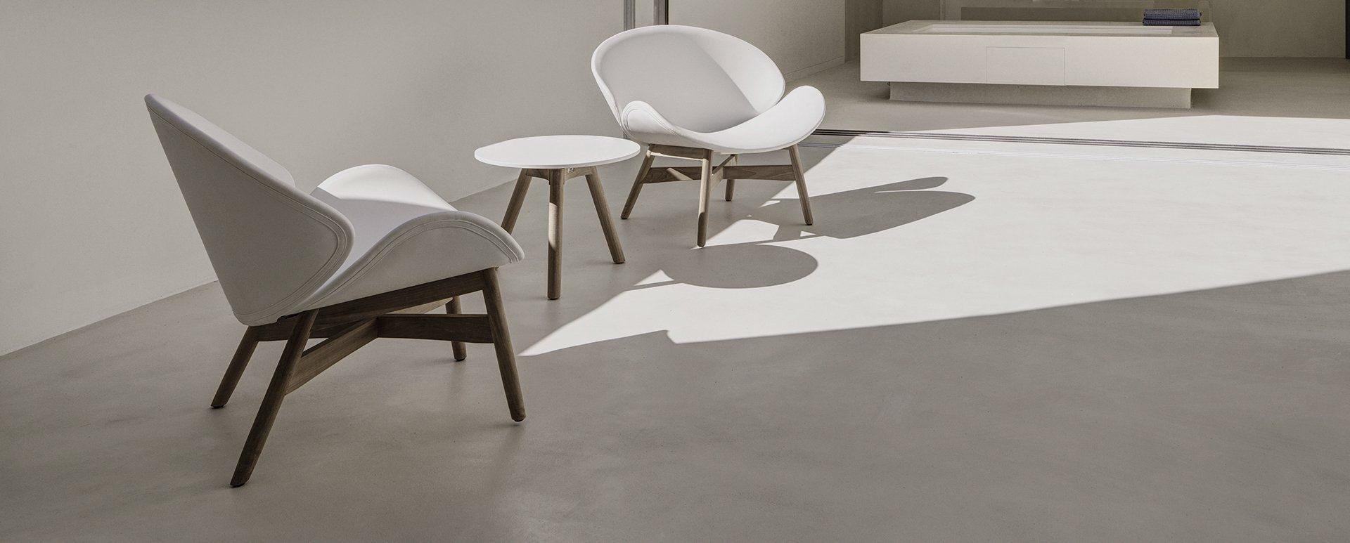 There are two chairs and a table in the room.