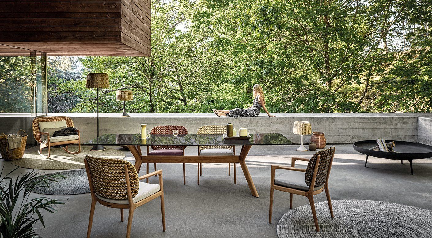 There is a table and chairs in the middle of the room.