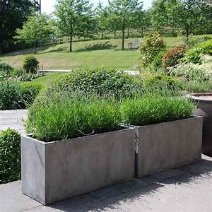 A couple of planters filled with plants in a garden.