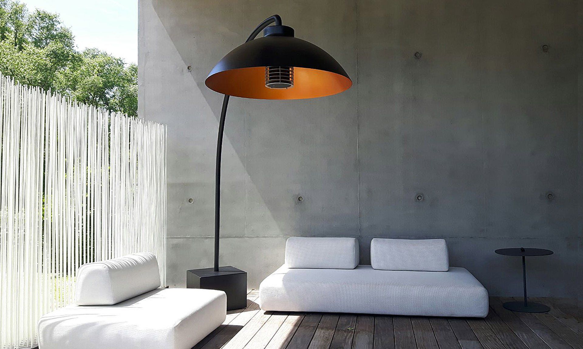 A patio with a couch and a lamp on it