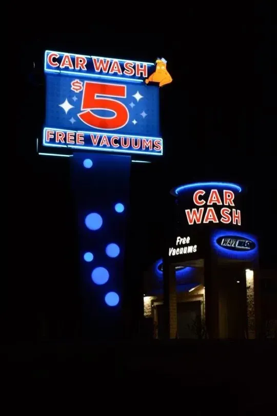Car wash sign at night. Blue and white sign with 