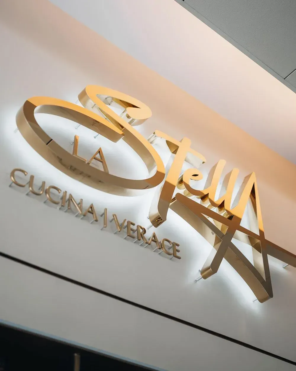 Gold illuminated restaurant sign reading 