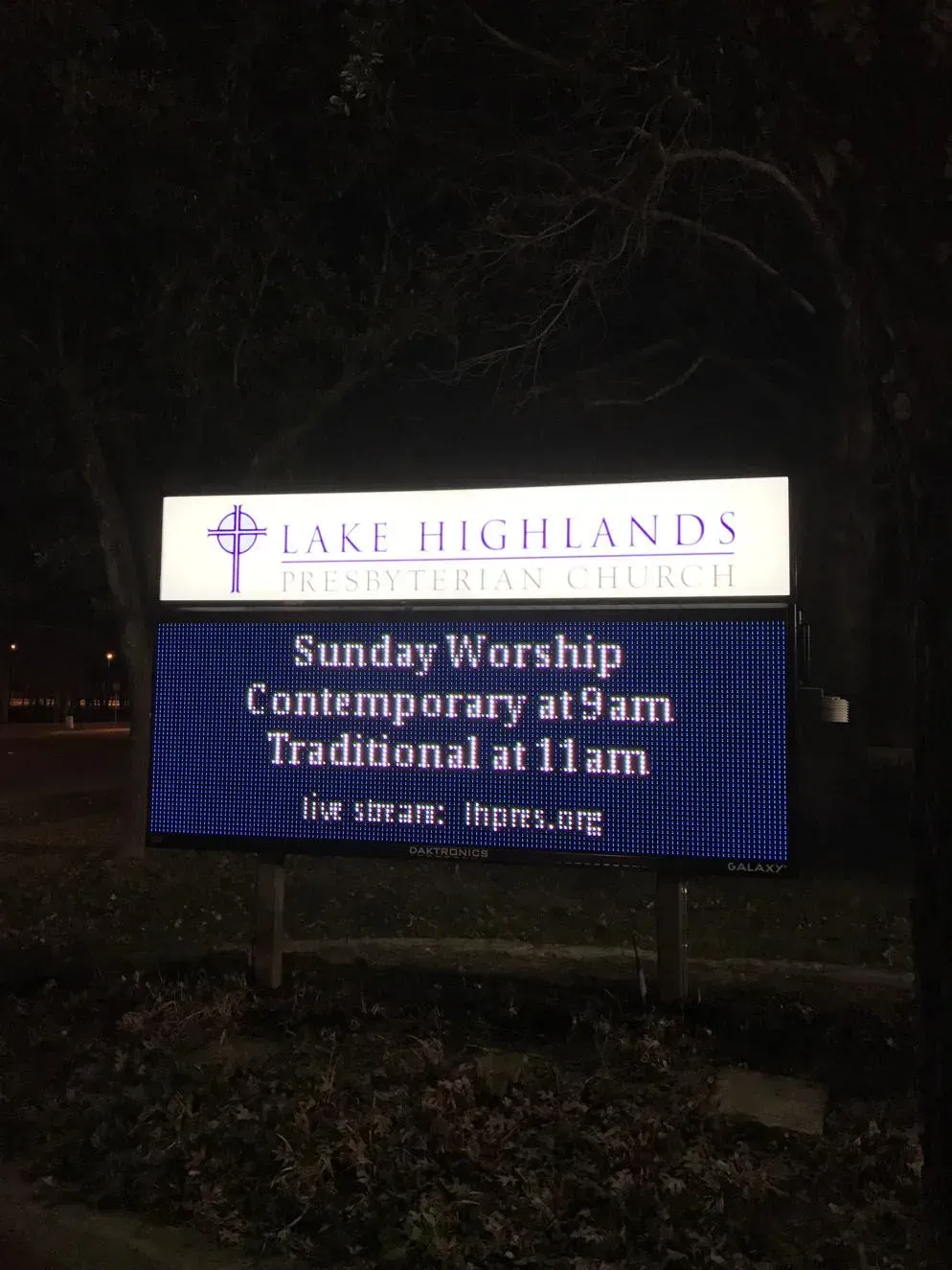 Church sign at night, reading: 