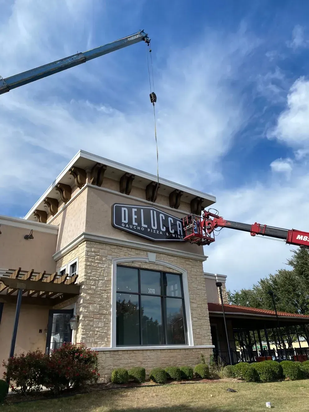 A crane and lift installing a 