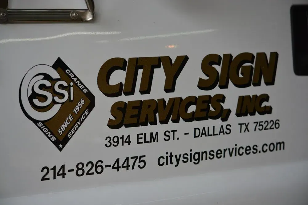Logo of City Sign Services, Inc. with address and phone number on a white surface.