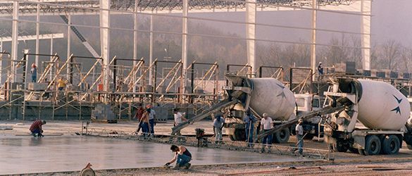 a group of construction workers are working on a concrete floor