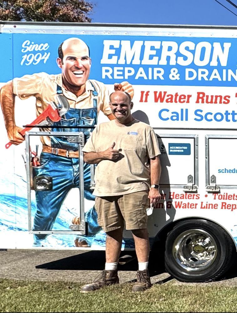 Man standing in front of an Emerson Repair & Drain service truck with a cartoon plumber graphic.
