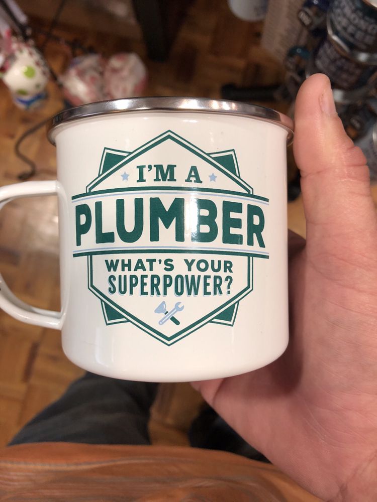 Hand holding a white mug