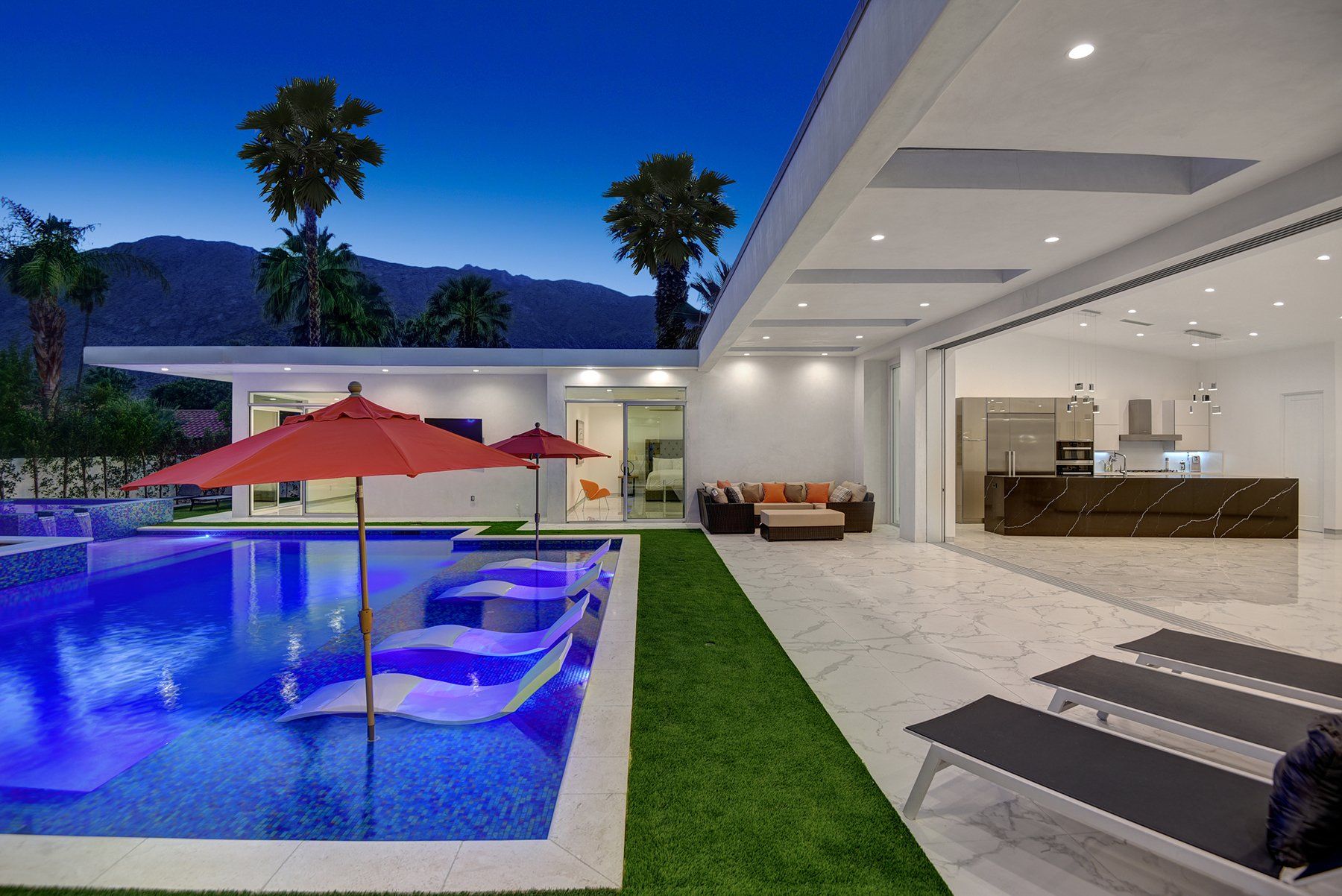 Across pool and house to mountains at night