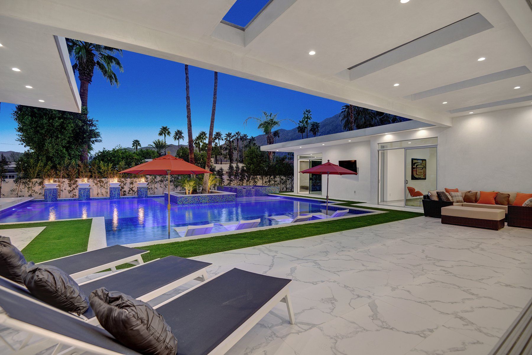 Chaises to pool and mountains at night