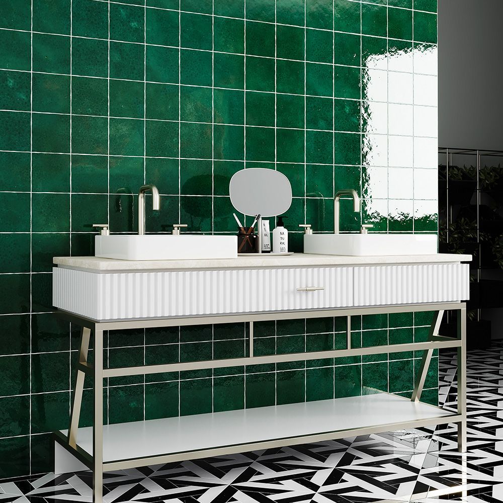 Bathroom with a white double vanity, green tiled wall, and black and white patterned floor.