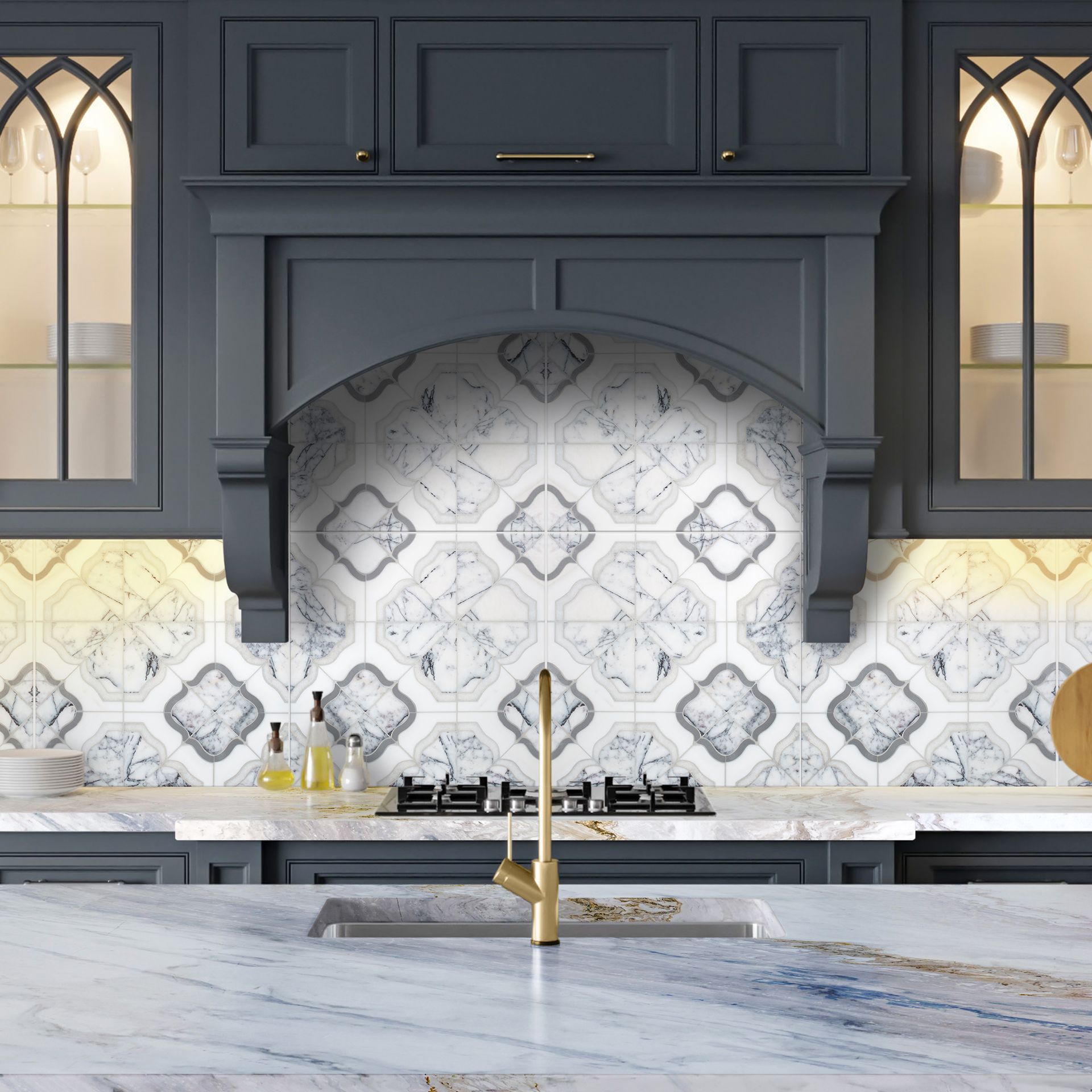 Blue kitchen with patterned backsplash, brass faucet, and overhead cabinets.