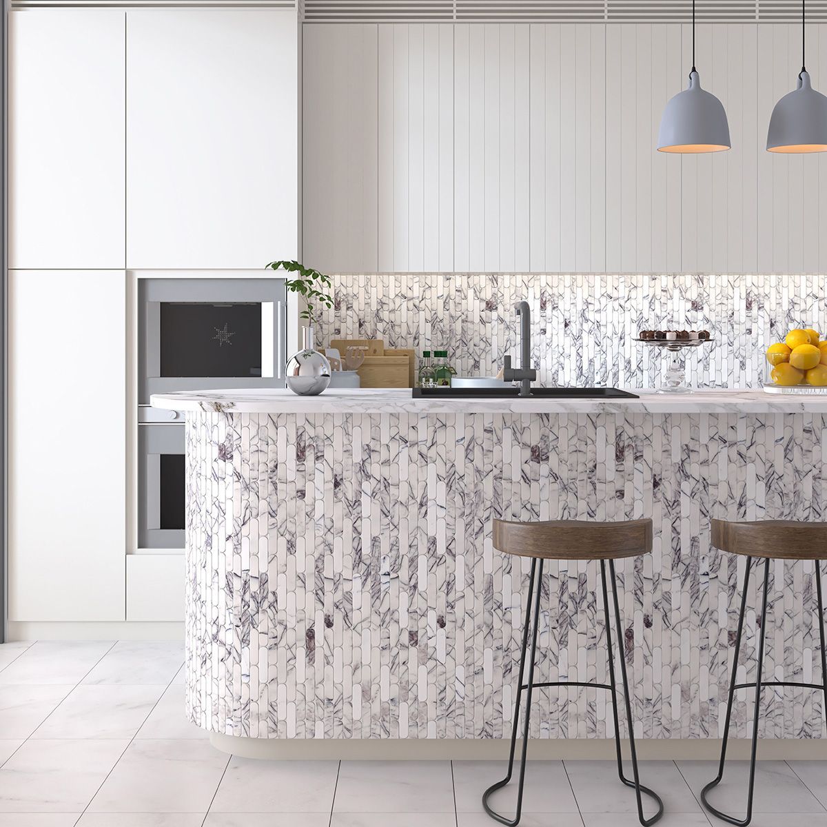 Modern white kitchen with marble island, stools, and overhead lighting.