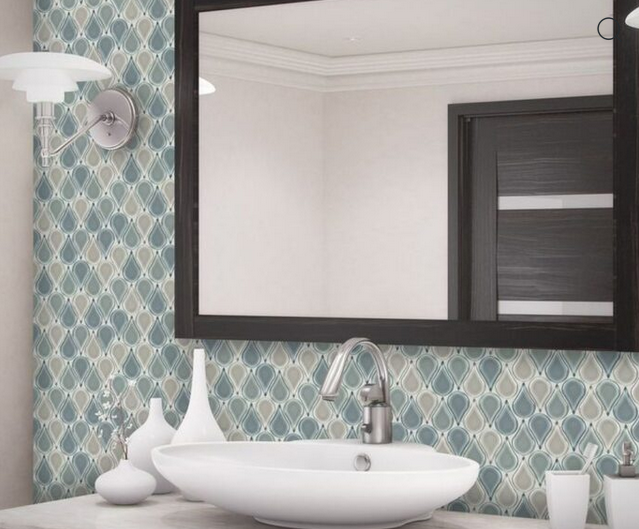 Bathroom with teal teardrop patterned tile, white sink, black mirror, and matching door.