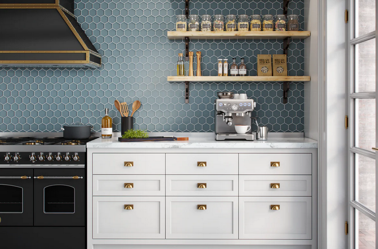 Kitchen with blue tile backsplash, white cabinets, black stove, and shelves with spices.