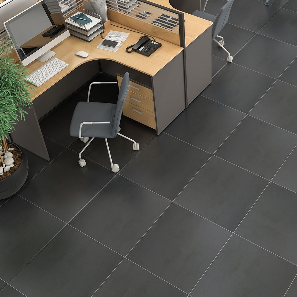 Office with dark gray tiled floor, desk, and chair.