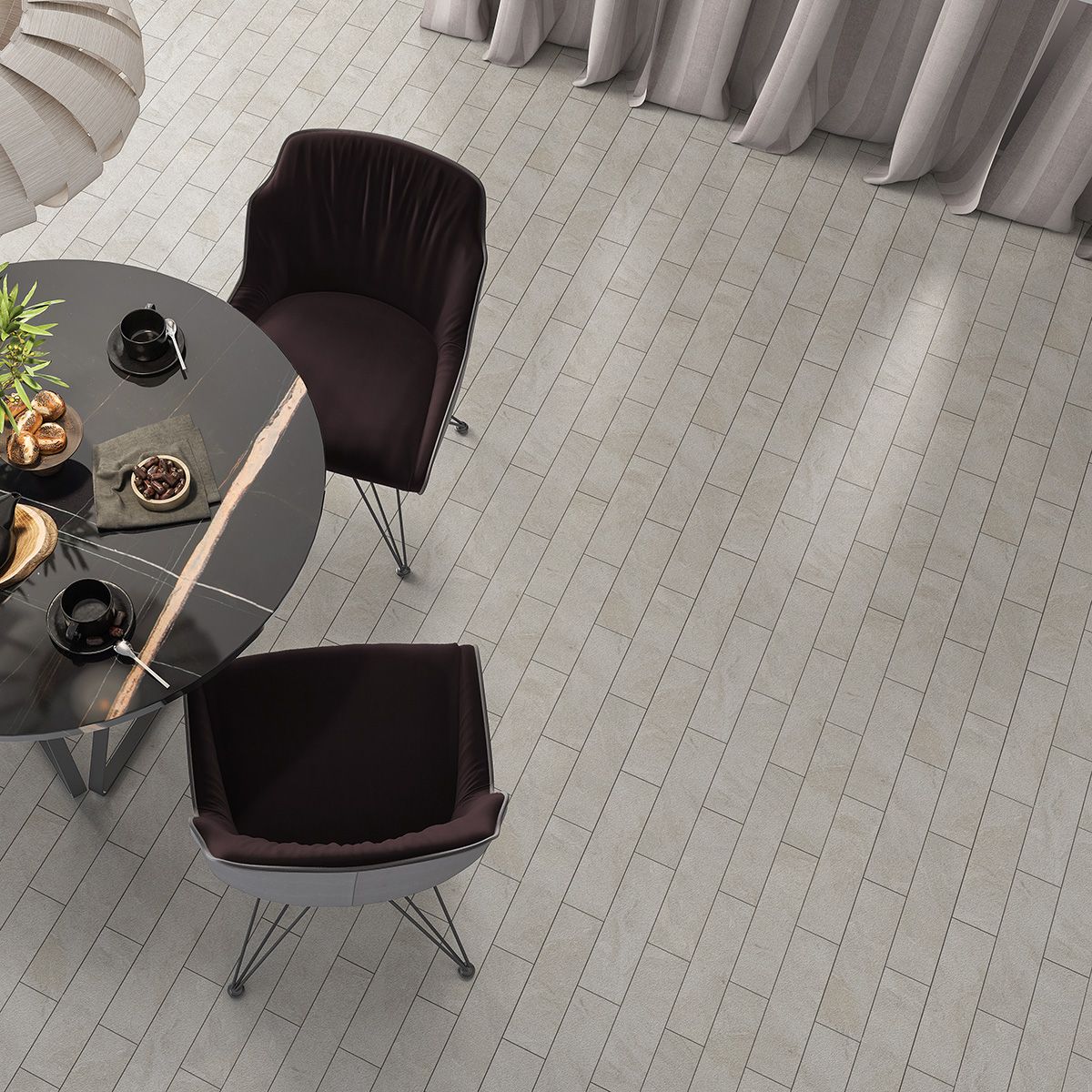 Dining area: black table with two dark chairs on light wood-look floor.