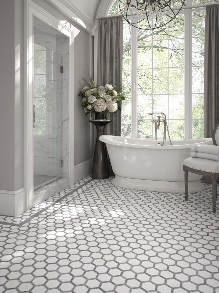Elegant bathroom with hexagonal tile floor, white tub, glass shower, and large window with drapes.