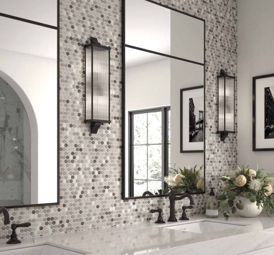 Bathroom with mosaic tile wall, black framed mirrors, sconces, and black fixtures.